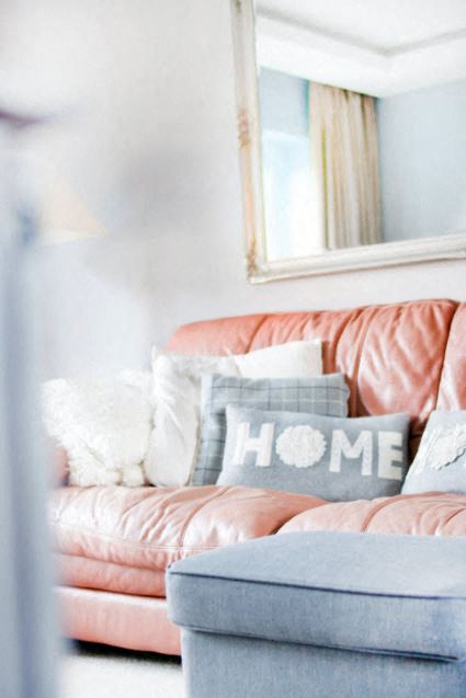 Couch showing pillow stating home